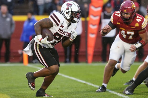 Texas Tech running back Tahj Brooks running the ball by Kooper Ebel against Iowa State.