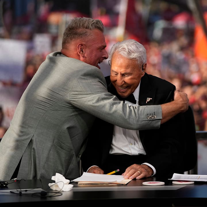 Pat McAfee hugs Lee Corso on the set of ESPN College GameDay prior to the NCAA football game between the Ohio State Buckeyes 