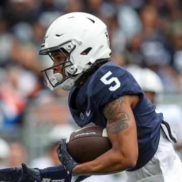 Penn State Nittany Lions wide receiver Omari Evans runs for a touchdown during the 2023 Blue-White spring game at Beaver Stadium. 