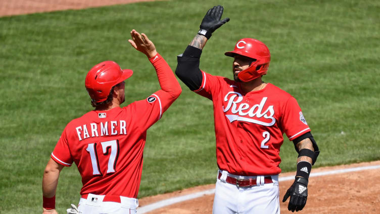 Reds players Kyle Farmer and Nick Castellanos celebrate.