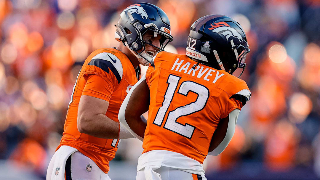 Oct 19, 2025; Denver, Colorado, USA; Denver Broncos quarterback Bo Nix (10) celebrates the touchdown of running back RJ Harvey (12) in the fourth quarter against the New York Giants at Empower Field at Mile High. 