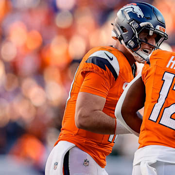 Oct 19, 2025; Denver, Colorado, USA; Denver Broncos quarterback Bo Nix (10) celebrates the touchdown of running back RJ Harvey (12) in the fourth quarter against the New York Giants at Empower Field at Mile High.  