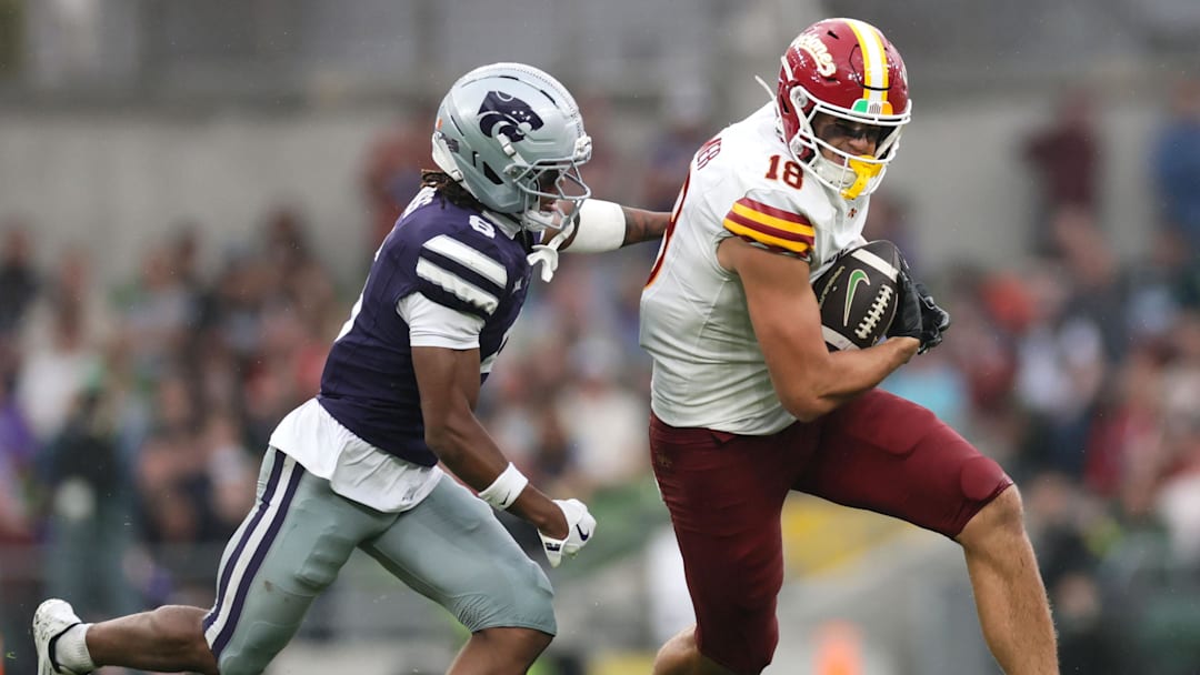 Aug 23, 2025; Dublin, IRELAND; Iowa State player Benjamin Brahmer runs with the ball against Qua Moss of Kansas State during the Aer Lingus Classic between Iowa State and Kansas State at Aviva Stadium. Mandatory Credit: Laszlo Geczo/INPHO via Imagn Images