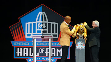 Aug 5, 2017; Canton, OH, USA; Jason Taylor pulls back the cloth of his bust with Jimmy Johnson (right) during the 2017 NFL Hall of Fame enshrinement at Tom Benson Hall of Fame Stadium. Mandatory Credit: Aaron Doster-Imagn Images