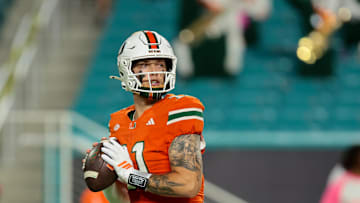 Oct 17, 2025; Miami Gardens, Florida, USA; Miami Hurricanes quarterback Carson Beck (11) looks for a passing option against the Louisville Cardinals during the third quarter at Hard Rock Stadium. Mandatory Credit: Sam Navarro-Imagn Images