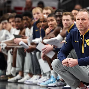Mar 12, 2025; Kansas City, MO, USA; West Virginia Mountaineers coach Darian DeVries watches game play during the first half against the Colorado Buffaloes at T-Mobile Center. Mandatory Credit: William Purnell-Imagn Images