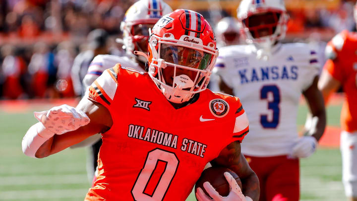 Oct 14, 2023; Stillwater, Oklahoma, USA; Oklahoma State's Ollie Gordon II (0) runs the ball in the second quarter for a touchdown against the Kansas Jayhawks at Boone Pickens Stadium. Mandatory Credit: Nathan J. Fish-USA TODAY Sports