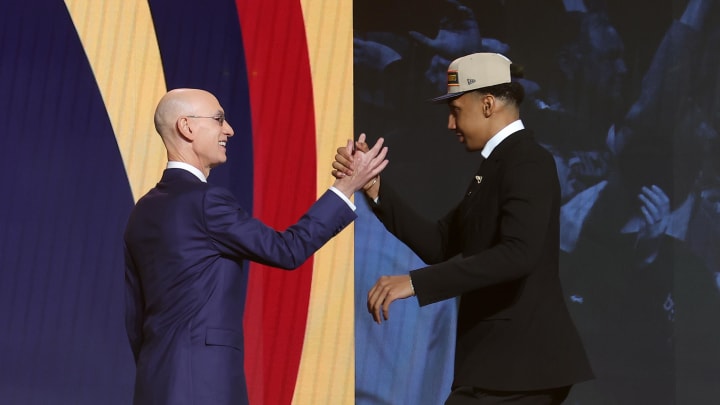Ryan Dunn shakes hands with NBA commissioner Adam Silver after being selected in the first round by the Denver Nuggets in the 2024 NBA Draft at Barclays Center.