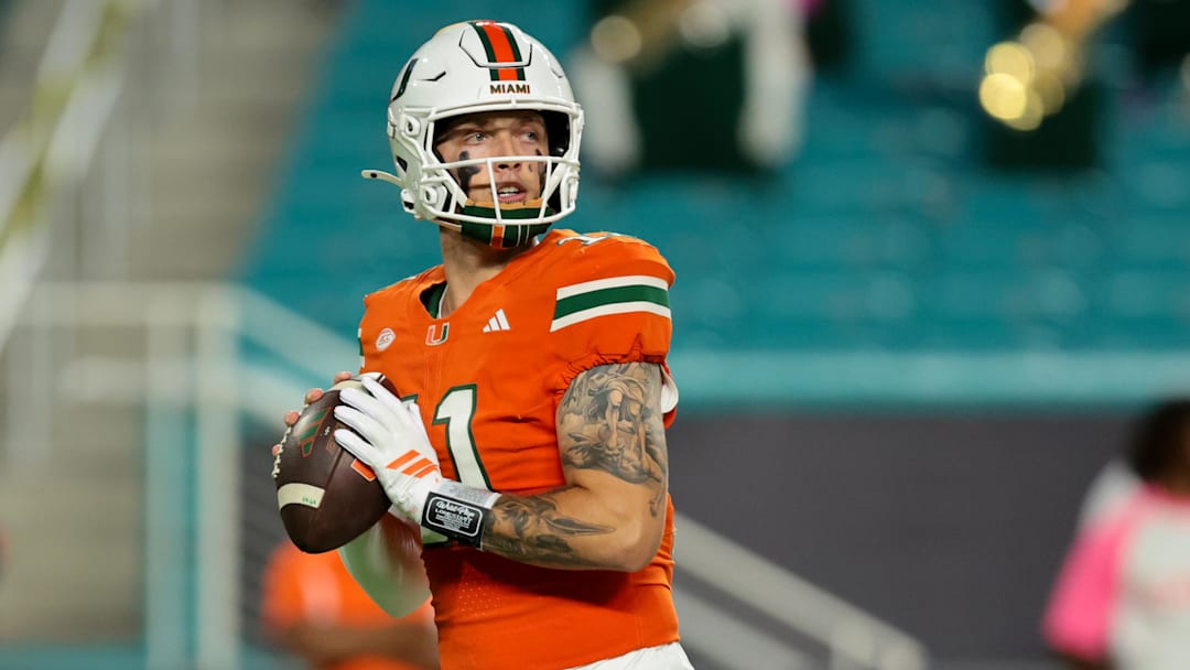 Oct 17, 2025; Miami Gardens, Florida, USA; Miami Hurricanes quarterback Carson Beck (11) looks for a passing option against the Louisville Cardinals.