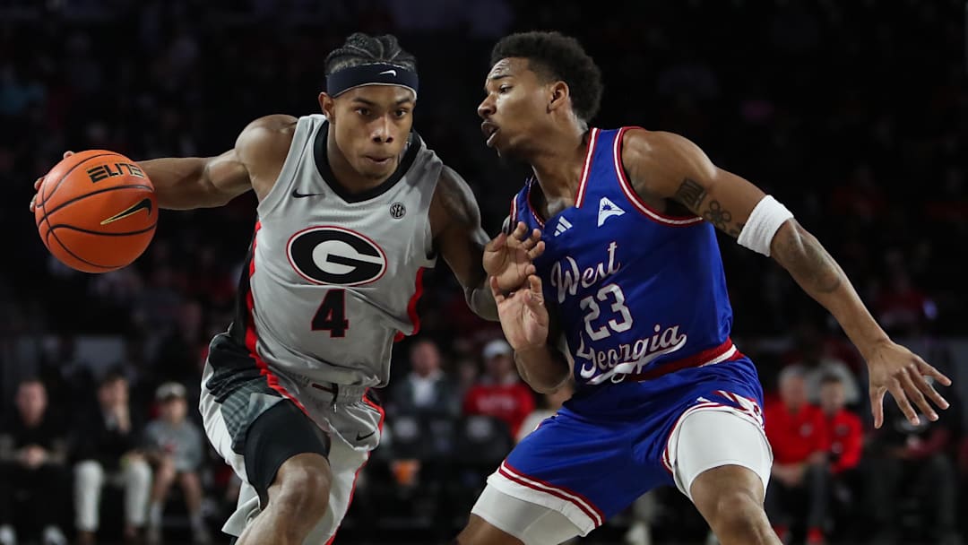 Dec 22, 2025; Athens, Georgia, USA; Georgia Bulldogs guard Marcus Millender (4) works past West Georgia Wolves guard Malcolm Noel (23) in the first half at Stegeman Coliseum. Mandatory Credit: Mady Mertens-Imagn Images