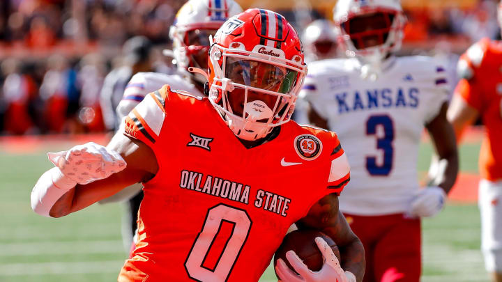 Oct 14, 2023; Stillwater, Oklahoma, USA; Oklahoma State's Ollie Gordon II (0) runs the ball in the second quarter for a touchdown against the Kansas Jayhawks at Boone Pickens Stadium. Mandatory Credit: Nathan J. Fish-USA TODAY Sports Oct 14, 2023; Stillwater, Oklahoma, USA; Oklahoma State's Ollie Gordon II (0) runs the ball in the second quarter for a touchdown against the Kansas Jayhawks at Boone Pickens Stadium. Mandatory Credit: Nathan J. Fish-USA TODAY Sports