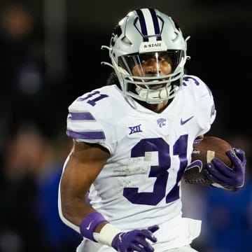 Nov 18, 2023; Lawrence, Kansas, USA; Kansas State Wildcats running back DJ Giddens (31) runs the ball during the first half against the Kansas Jayhawks at David Booth Kansas Memorial Stadium. Mandatory Credit: Jay Biggerstaff-USA TODAY Sports