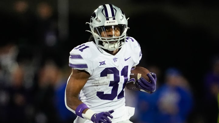 Nov 18, 2023; Lawrence, Kansas, USA; Kansas State Wildcats running back DJ Giddens (31) runs the ball during the first half against the Kansas Jayhawks at David Booth Kansas Memorial Stadium. Mandatory Credit: Jay Biggerstaff-USA TODAY Sports