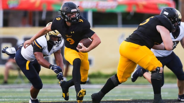 Bishop Verot Vikings quarterback Carter Smith (9) breaks a tackle during the first quarter of a preseason game against the St