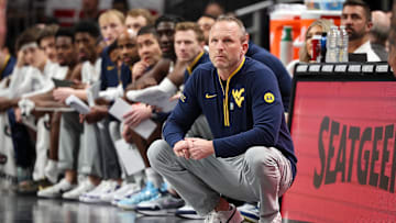 Mar 12, 2025; Kansas City, MO, USA; West Virginia Mountaineers coach Darian DeVries watches game play during the first half against the Colorado Buffaloes at T-Mobile Center. Mandatory Credit: William Purnell-Imagn Images