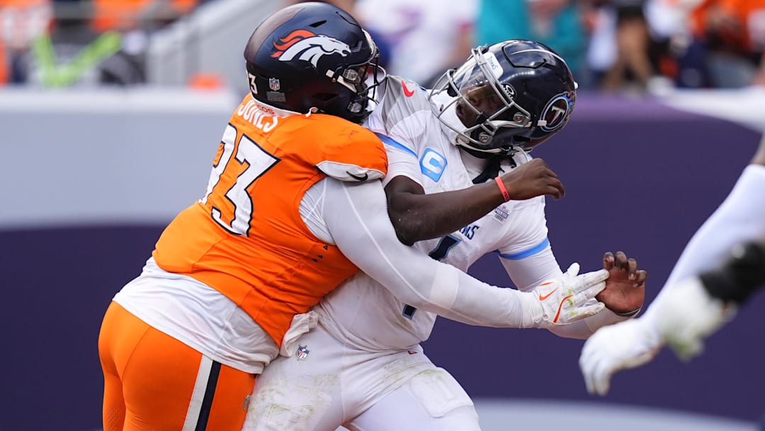 Sep 7, 2025; Denver, Colorado, USA; Denver Broncos defensive tackle D.J. Jones (93) hits Tennessee Titans quarterback Cam Ward (1) in the second half at Empower Field at Mile High. Sep 7, 2025; Denver, Colorado, USA; Denver Broncos defensive tackle D.J. Jones (93) hits Tennessee Titans quarterback Cam Ward (1) in the second half at Empower Field at Mile High.