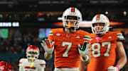 Oct 17, 2025; Miami Gardens, Florida, USA; Miami Hurricanes wide receiver CJ Daniels (7) celebrates after scoring on a two-point conversion against the Louisville Cardinals during the fourth quarter at Hard Rock Stadium. Mandatory Credit: Sam Navarro-Imagn Images