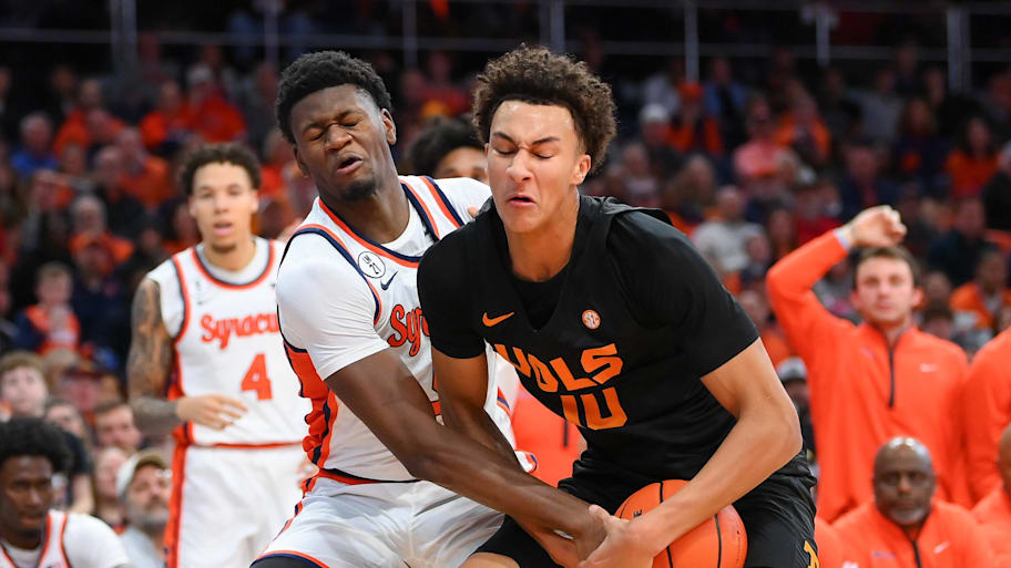 Syracuse forward Tyler Betsey (left) and Tennessee forward Nate Ament battle for the ball.