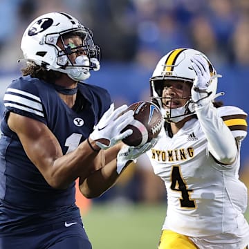 Sep 24, 2022; Provo, Utah, USA; Brigham Young Cougars wide receiver Keanu Hill (1) makes a catch for a touchdown in front of Wyoming Cowboys cornerback Cameron Stone (4) in the fourth quarter at LaVell Edwards Stadium.