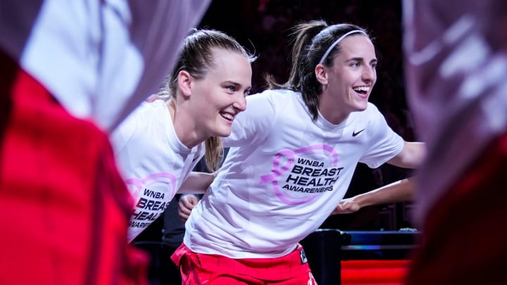 Indiana Fever guard Kristy Wallace (3) and Indiana Fever guard Caitlin Clark (22) smile in a huddle Friday, Aug. 16, 2024, before the game at Gainbridge Fieldhouse in Indianapolis.