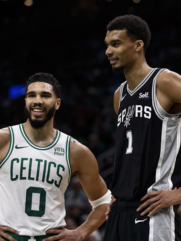 Boston Celtics forward Jayson Tatum (0) and San Antonio Spurs center Victor Wembanyama (1) share a laugh at TD Garden.