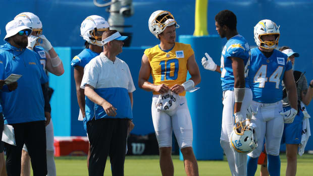 Jul 24, 2024; El Segundo, CA, USA;  Los Angeles Chargers quarterback Justin Herbert (10) talks to tight end Donald Parham Jr.