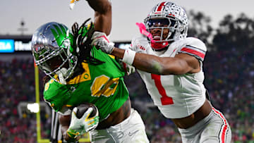 Ohio State Buckeyes cornerback Davison Igbinosun (1) pushes Oregon Ducks running back Noah Whittington (6) out of bounds in the second half of the 2025 Rose Bowl college football quarterfinal game at Rose Bowl Stadium.