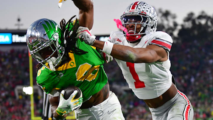 Ohio State Buckeyes cornerback Davison Igbinosun (1) pushes Oregon Ducks running back Noah Whittington (6) out of bounds in the second half of the 2025 Rose Bowl college football quarterfinal game at Rose Bowl Stadium.