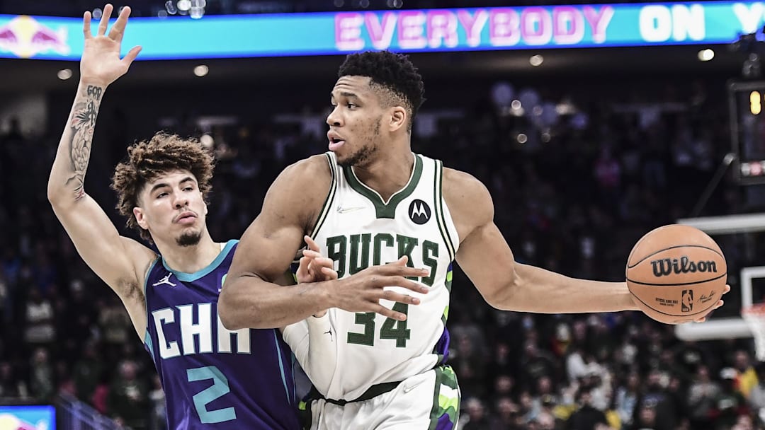 Dec 1, 2021; Milwaukee, Wisconsin, USA;  Milwaukee Bucks forward Giannis Antetokounmpo (34) drives for the basket against Charlotte Hornets guard LaMelo Ball (2) in the fourth quarter at Fiserv Forum. Mandatory Credit: Benny Sieu-Imagn Images