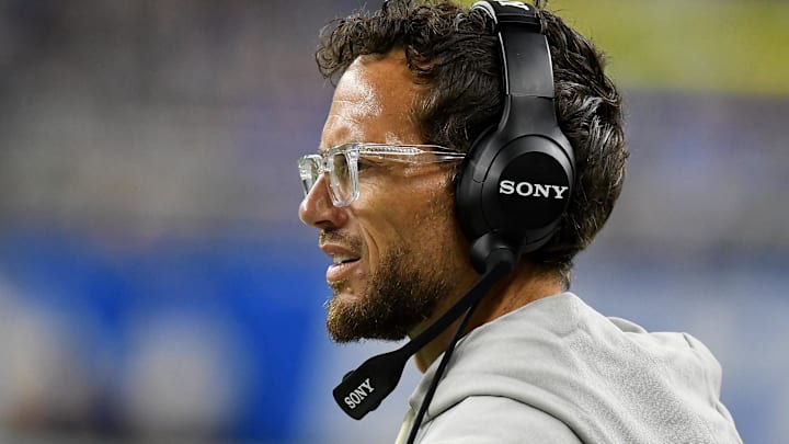 Aug 16, 2025; Detroit, Michigan, USA; Former Miami Dolphins head coach Mike McDaniels looks on from the sidelines in their game against the Detroit Lions in the first quarter at Ford Field.