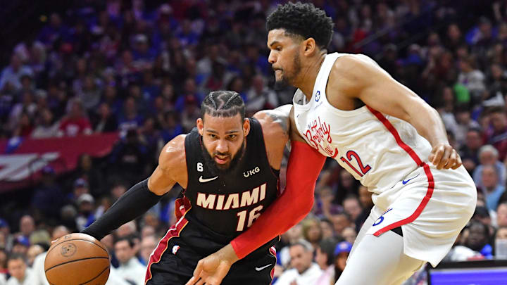 Apr 6, 2023; Philadelphia, Pennsylvania, USA; Miami Heat forward Caleb Martin (16) is defended by Philadelphia 76ers forward Tobias Harris (12) during the second quarter at Wells Fargo Center. Mandatory Credit: Eric Hartline-Imagn Images