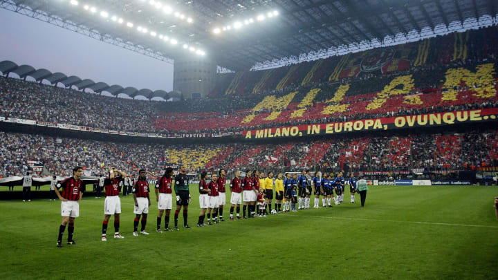 AC Milan and Inter Milan players line-up in front of an amazing atmosphere