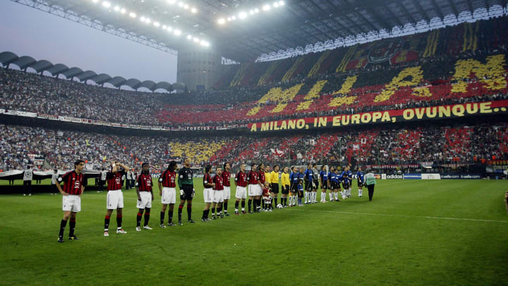 AC Milan and Inter Milan players line-up in front of an amazing atmosphere