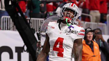 Jan 20, 2025; Atlanta, GA, USA; Ohio State Buckeyes wide receiver Jeremiah Smith (4) reacts after scoring against the Notre Dame Fighting Irish a touchdown during the first half the CFP National Championship college football game at Mercedes-Benz Stadium. Mandatory Credit: Brett Davis-Imagn Images
