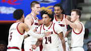 Louisville guard Chucky Hepburn (24) celebrates with teammates during the win over West Virginia Thursday in the Bahamas.  