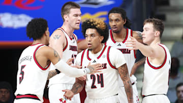 Louisville guard Chucky Hepburn (24) celebrates with teammates during the win over West Virginia Thursday in the Bahamas.  