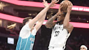 Oct 22, 2025; Charlotte, North Carolina, USA; Brooklyn Nets center Nic Claxton (33) looks to pass as he is defended by Charlotte Hornets centenaries Ryan Kalkbrenner (11) during the first half at the Spectrum Center. Mandatory Credit: Sam Sharpe-Imagn Images