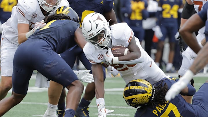 Sep 7, 2024; Ann Arbor, Michigan, USA; Texas Longhorns running back Quintrevion Wisner (26) is tackled by Michigan Wolverines defensive back Makari Paige (7) in the first half at Michigan Stadium. Mandatory Credit: Rick Osentoski-Imagn Images