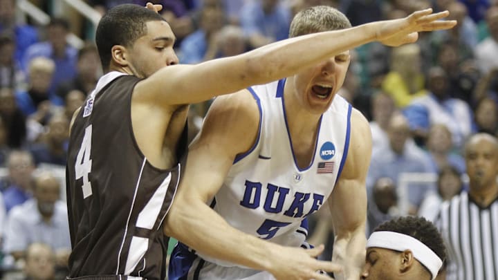 Mar 16, 2012; Greensboro, NC, USA; Duke Blue Devils forward Mason Plumlee (5) fights for the ball with Lehigh Mountain Hawks forward John Adams (4) and guard Mackey McKnight (11).
