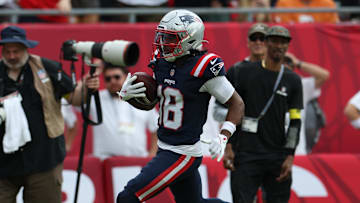 Nov 9, 2025; Tampa, Florida, USA; New England Patriots wide receiver Kyle Williams (18) runs for a touchdown during the second quarter against the Tampa Bay Buccaneers at Raymond James Stadium. Mandatory Credit: Nathan Ray Seebeck-Imagn Images