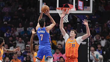 Nov 15, 2025; Charlotte, North Carolina, USA; Oklahoma City Thunder center Chet Holmgren (7) shoots over Charlotte Hornets center Ryan Kalkbrenner (11) during the ffirst half at Spectrum Center. Mandatory Credit: Jim Dedmon-Imagn Images