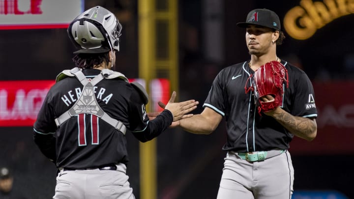 Sep 3, 2024; San Francisco, California, USA;  Arizona Diamondbacks catcher Jose Herrera (11) and pitcher Justin Martinez (63) celebrate their team’s 8-7 win over the San Francisco Giants at Oracle Park. Mandatory Credit: John Hefti-Imagn Images