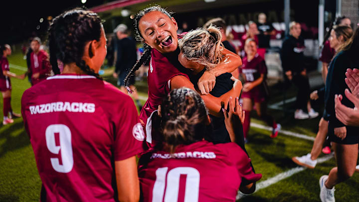 Arkansas players celebrate a 3-1 win against Alabama on Thursday night at Razorback Field in Fayetteville, Ark.