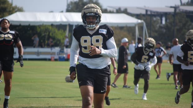 Payton Turner going through stretch at Saints training camp practice.