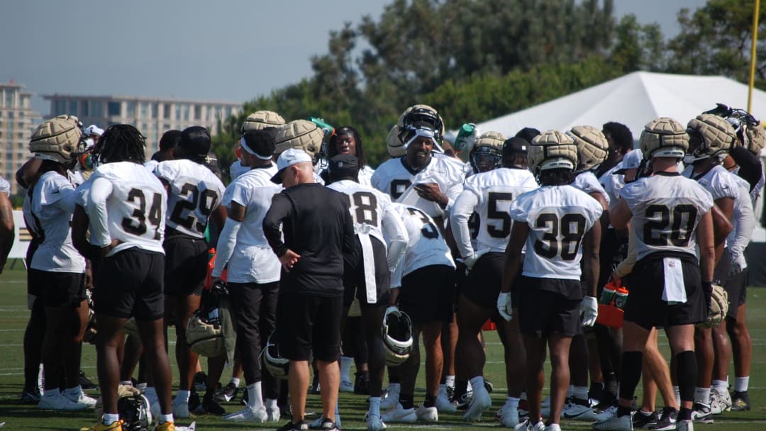 Cam Jordan leads the Saints defense with a chat beore training camp practice gets into gear.