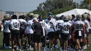 Cam Jordan leads the Saints defense with a chat beore training camp practice gets into gear.