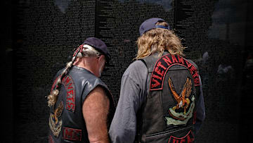 Two Vietnam War veterans at the Vietnam Veterans Memorial.