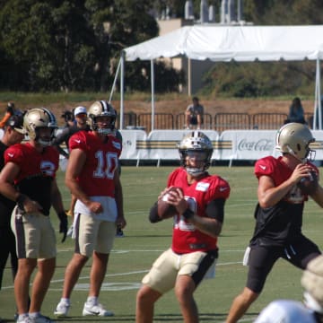 Spencer Rattler and Derek Carr going through passing drills at Saints training camp.