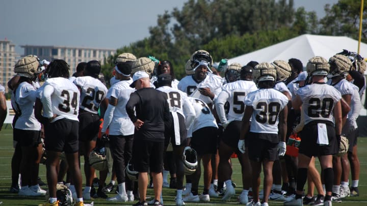 Cam Jordan leads the Saints defense with a chat beore training camp practice gets into gear.