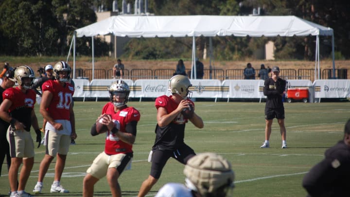 Spencer Rattler and Derek Carr going through passing drills at Saints training camp.